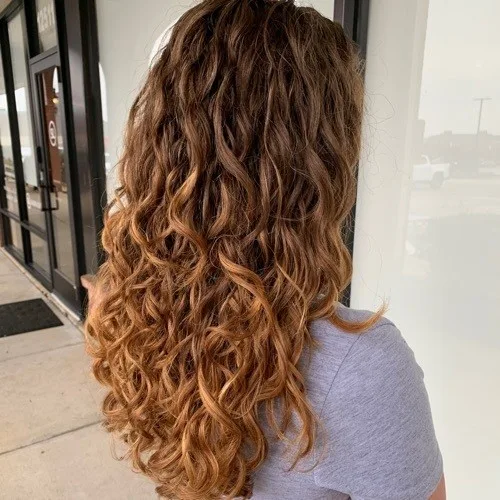 Client with copper balayage curls colored at Curls Done Wright