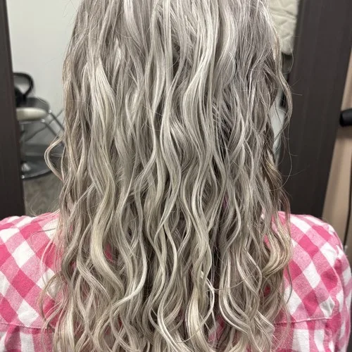 Client with silver blonde waves colored and styled at Curls Done Wright