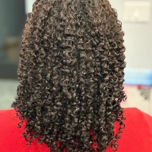 Client with healthy tight coils styled at Curls Done Wright