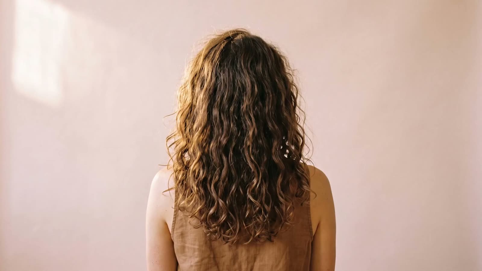 Before the cut: long natural curls at rest, undefined